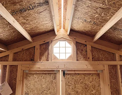 Side gable shed interior with octagonal window