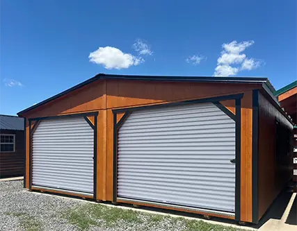 Exterior of double wide utility shed with roll up garage doors